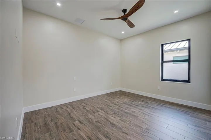 Spare room featuring dark wood finished floors, recessed lighting, and ceiling fan