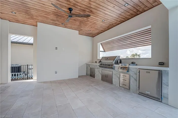 View of patio featuring ceiling fan and exterior kitchen