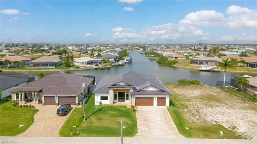 Aerial perspective of suburban area featuring a large body of water