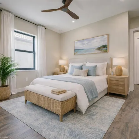 Bedroom with wood finished floors, ceiling fan, and recessed lighting