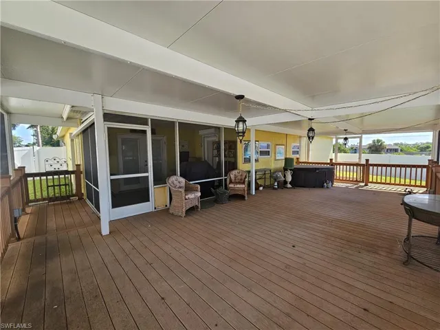 Wooden deck featuring a sunroom