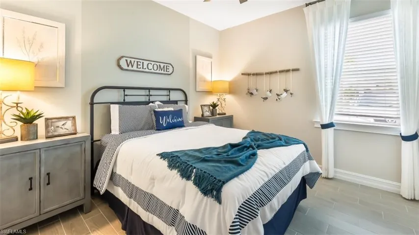 Wood-finish flooring, window with blinds, and white curtains