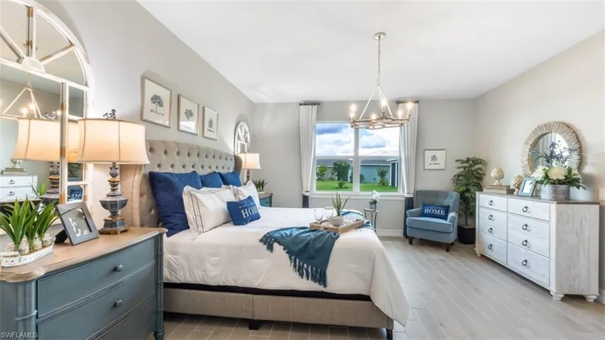 Light wood-finish flooring, recessed lighting, and a window with white trim