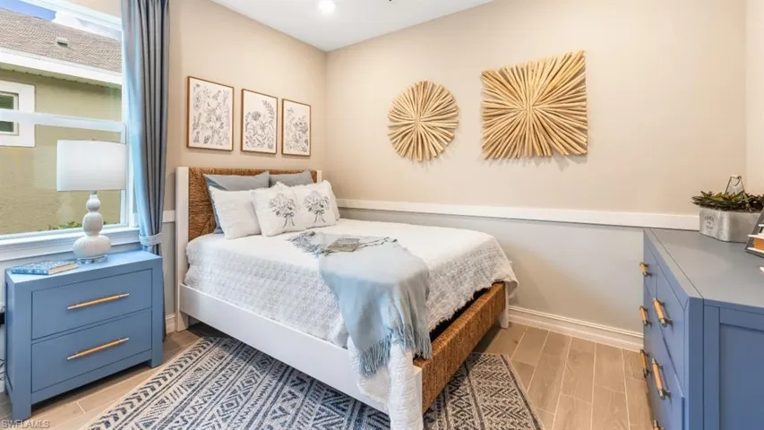 Recessed ceiling lighting illuminates light-toned wall finishes and wood-finish flooring