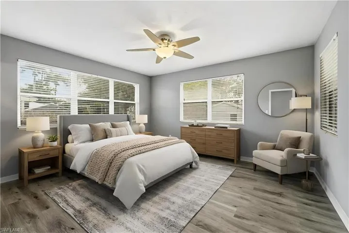 Virtually staged Bedroom featuring ceiling fan, light wood-type flooring, and multiple windows