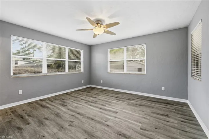 Spare room featuring wood finished floors and ceiling fan