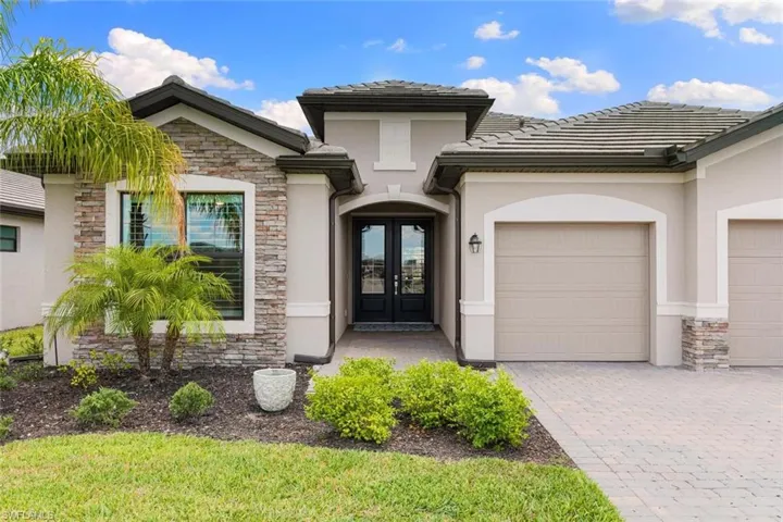 View of front of property featuring french doors and a garage
