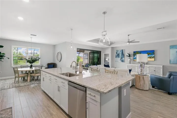 Kitchen featuring ceiling fan, dishwasher, sink, and a wealth of natural light