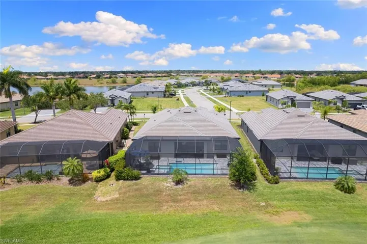Birds eye view of property with a water view