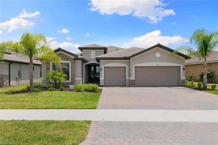 View of front of home featuring a garage and a front lawn