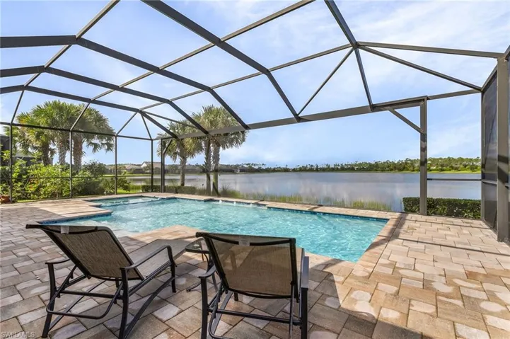 View of pool featuring a water view, a patio, and a lanai