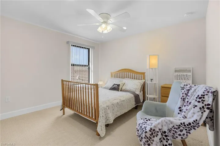 Bedroom with ceiling fan and carpet