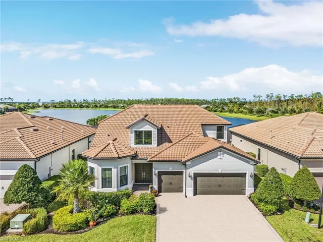 Mediterranean / spanish-style home with a water view and a garage