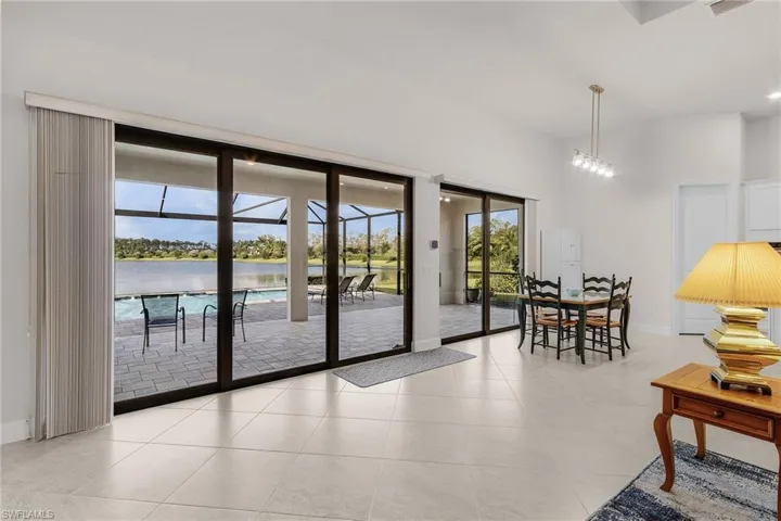 Doorway to outside with a water view and light tile patterned floors