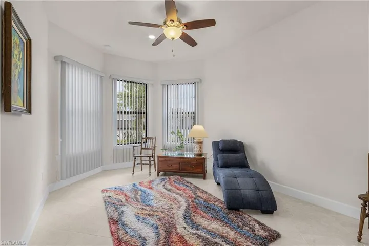 Sitting room featuring ceiling fan and light tile patterned floors