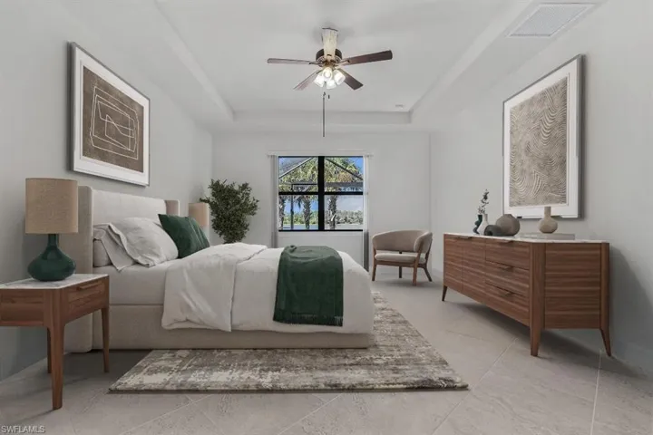 Tiled bedroom with a raised ceiling and ceiling fan