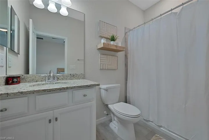 Bathroom featuring vanity and wood finished floors
