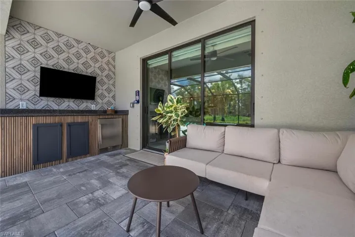 Living room featuring a ceiling fan and a sunroom