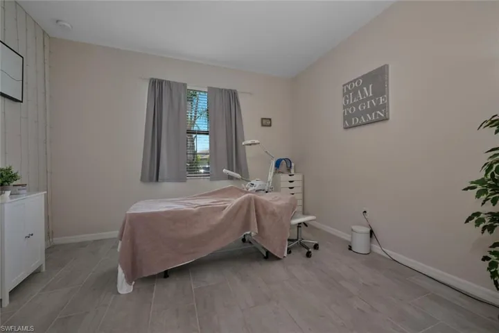 Bedroom with light wood finished floors and wooden walls