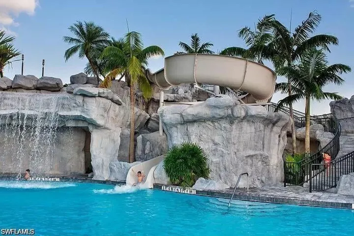 Outdoor pool featuring a water slide