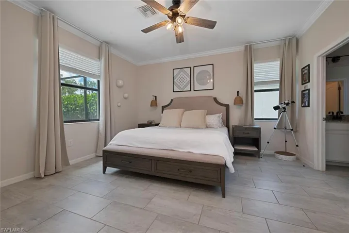 Bedroom featuring ornamental molding and a ceiling fan