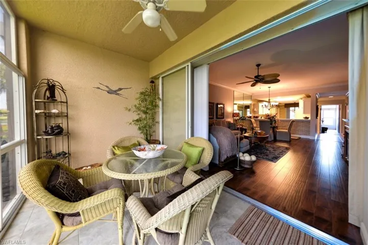 Sunroom / solarium with ceiling fan with notable chandelier