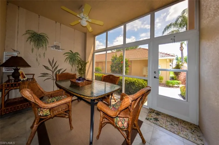 Sunroom featuring ceiling fan and a wealth of natural light