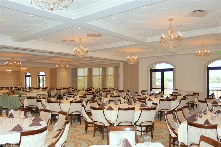 Dining area featuring french doors, crown molding, coffered ceiling, and plenty of natural light