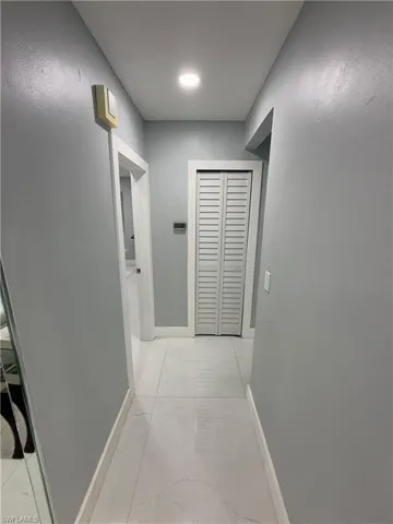 Hallway featuring baseboards