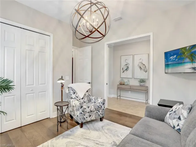 Sitting room with an inviting chandelier and dark hardwood / wood-style flooring