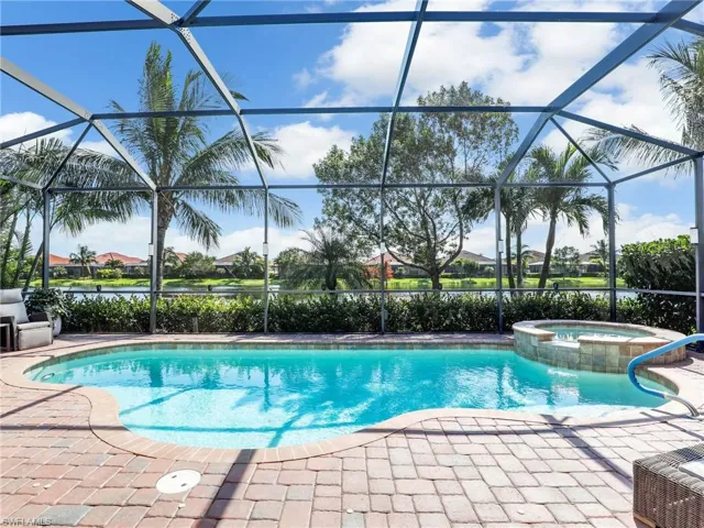 View of pool featuring a patio, an in ground hot tub, and screened enclosure