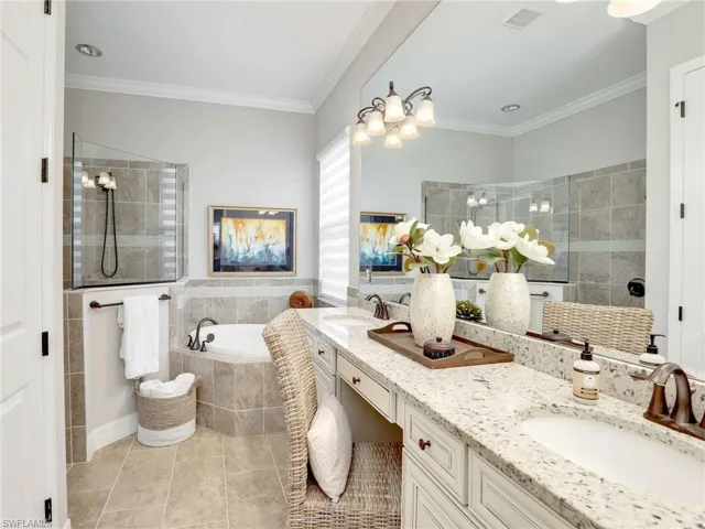 Bathroom featuring vanity, separate shower and tub, ornamental molding, and tile patterned floors
