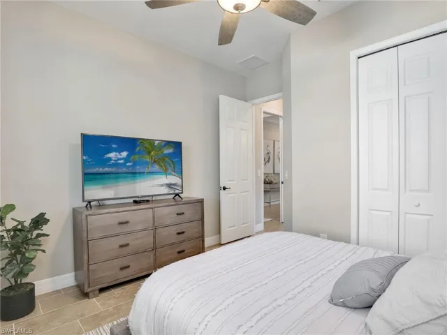 Tiled bedroom featuring a closet and ceiling fan