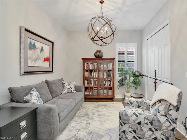 Living room with an inviting chandelier and hardwood / wood-style floors