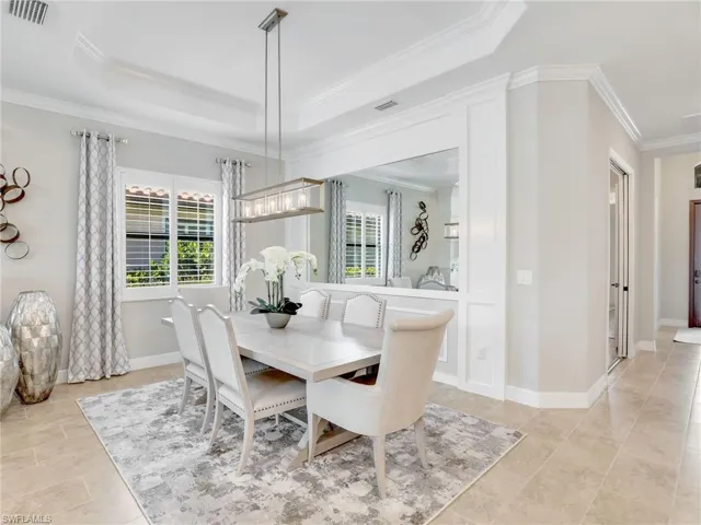 Dining area featuring crown molding and a tray ceiling