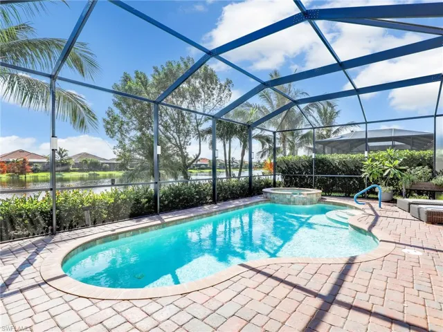 View of pool with a patio, an in ground hot tub, a water view, and screened enclosure