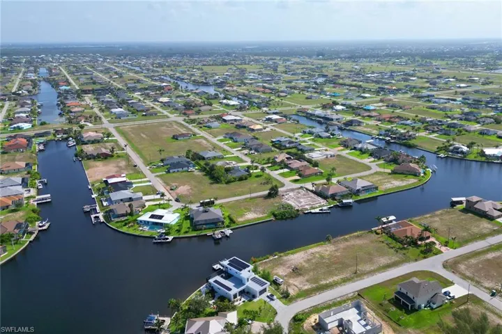 Aerial overview of property's location with nearby suburban area and a nearby body of water