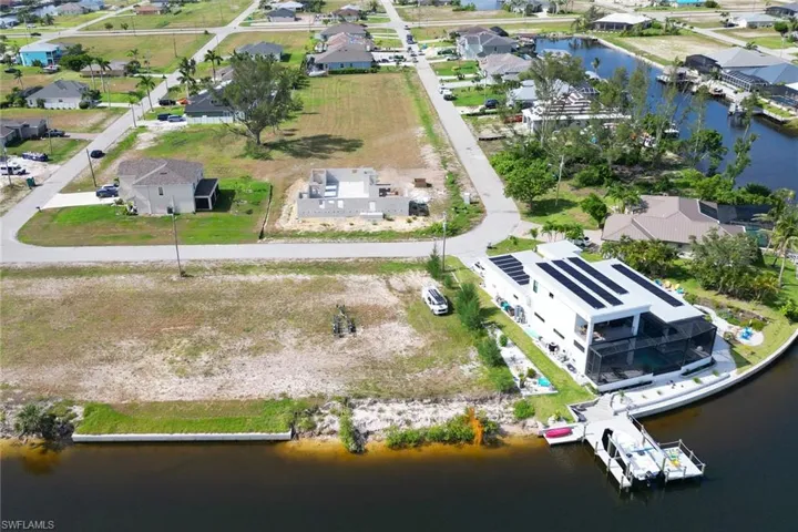 Aerial view of residential area featuring a nearby body of water