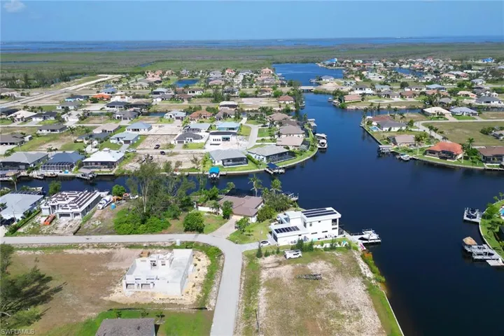 View of property location featuring a nearby body of water and nearby suburban area