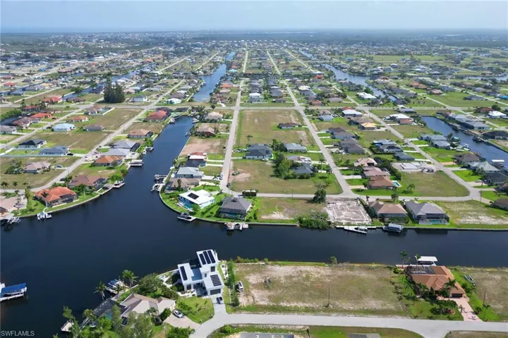 Aerial overview of property's location with nearby suburban area and a nearby body of water
