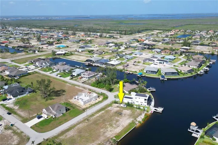 Aerial view of property's location with nearby suburban area and a large body of water