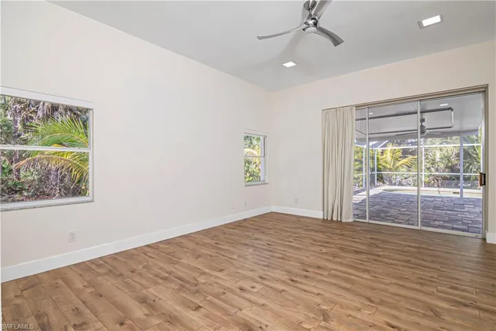 Empty room with wood finished floors and ceiling fan