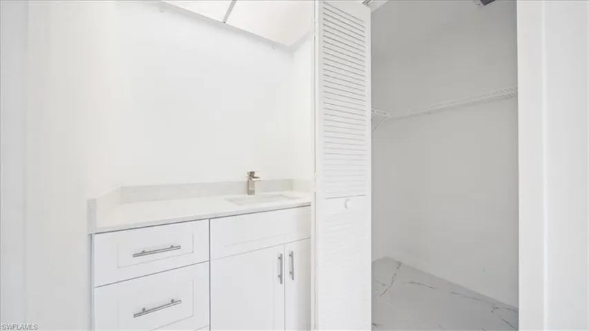 Bathroom featuring vanity and marble finish floors