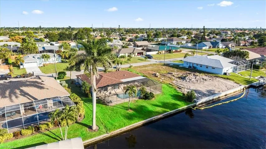 Aerial perspective of suburban area with a nearby body of water