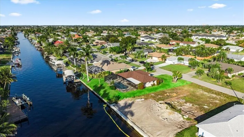 Aerial view of residential area featuring a nearby body of water