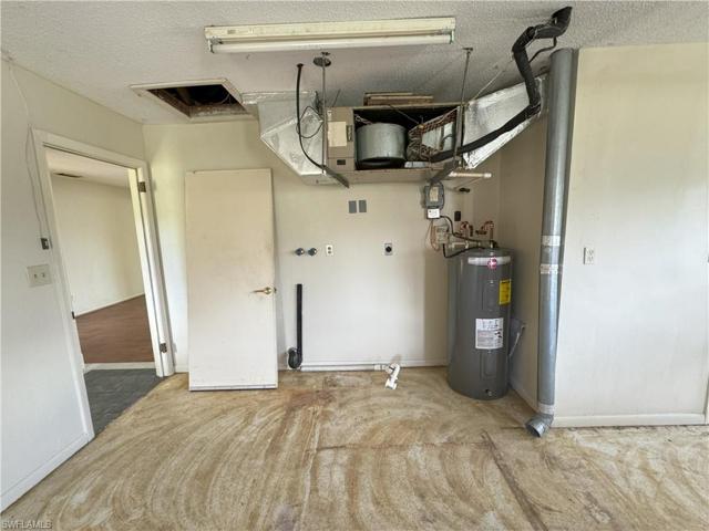 Partial view of garage where laundry exists and entry into home
