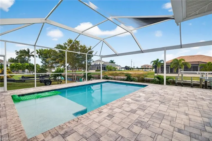 Swimming pool with a lanai, a sunroom, and a patio