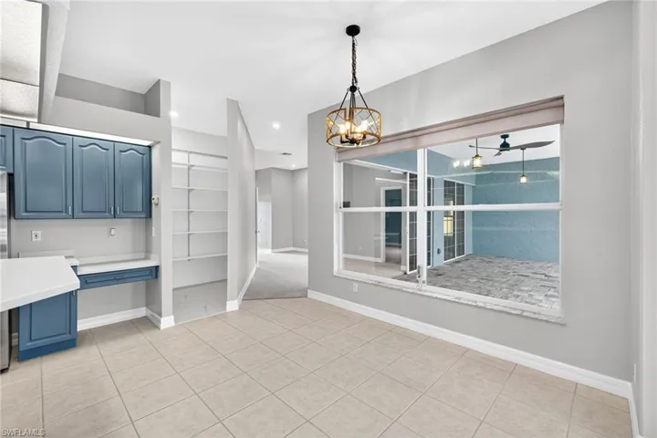 Unfurnished dining area featuring light tile patterned floors, a chandelier, a ceiling fan, and recessed lighting