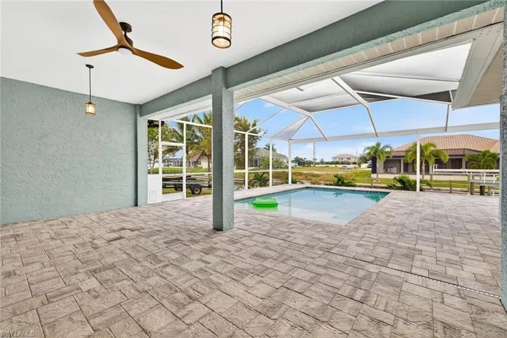 Outdoor pool with a patio area, a ceiling fan, a lanai, and a sunroom