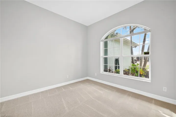 Spare room featuring baseboards and light colored carpet